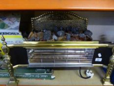 A decorative brass electric fire with coals