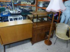 A teak television cabinet together with a teak radiogram cabinet, coffee table,