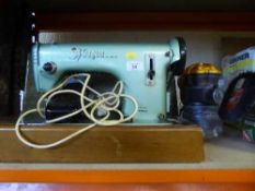 A cased Husqvarna Viking electric sewing machine together with a Dyson hand held vac