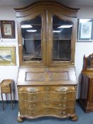 A continental oak bureau bookcase with serpentine front