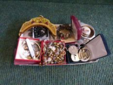 A box of assorted costume jewellery, brooches, bangles, necklaces, pipe cleaners,