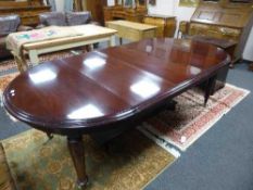 A Victorian style mahogany extending dining table with four leaves,