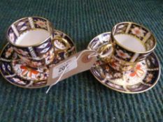 Two Royal Crown Derby gilded cups and saucers