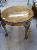 A heavily carved walnut circular coffee table