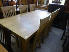 A pine farmhouse kitchen table and six rail back chairs