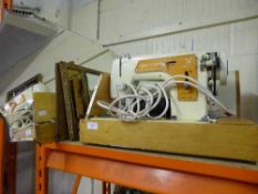 A cased Frister + Rossmann model 35 sewing machine together with a frameless mirror and a brass