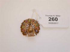A 9ct gold and multi-stone peacock brooch