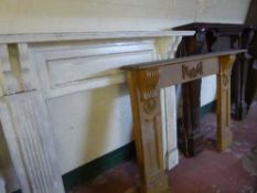 An early twentieth century carved mahogany fire surround together with painted fire surround and