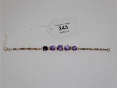 A 9ct gold and amethyst and cubic zirconia set bracelet,