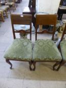 A set of four late nineteenth century mahogany dining chairs on cabriole legs