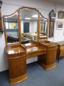 A continental serpentine fronted mahogany dressing table