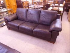 A brown leather three seater settee and armchair