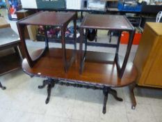 A contemporary oval mahogany coffee table together with pair of lamp tables
