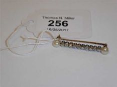 A diamond and seed pearl bar brooch