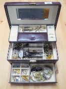 A jewellery box containing assorted costume jewellery, wristwatches, brooches,