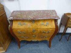 A continental walnut ormolu mounted marble top chest