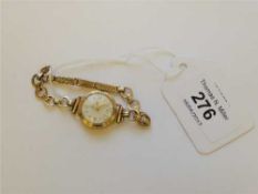 A lady's 9ct gold Tudor wristwatch upon 9ct gold bracelet, 14.