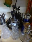 A tray of four plated topped claret jugs,