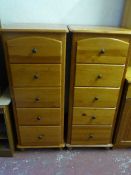 A pair of narrow pine five drawer chests