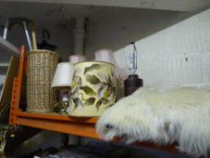 A wicker stick stand containing walking sticks, umbrellas,