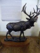 A cast metal figure - Stag on wooden base
