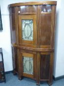A continental mahogany corner cabinet