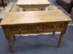 A Victorian style pine three drawer table