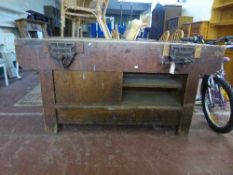 A heavy duty work bench fitted with two vice
