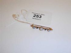 A 15ct gold opal and sapphire set bar brooch