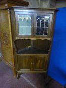 An oak leaded glass door corner cabinet