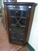 A 19th century mahogany hanging glazed door corner cupboard