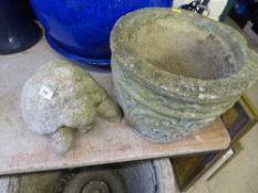 A garden planter and a garden figure of a tortoise