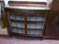 A mahogany double door display cabinet on claw and ball feet