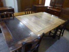 An oak early 20th century pull out table and four chairs