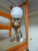 A converted brass oil lamp with shade and chimney,