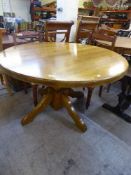 An oak pedestal dining table