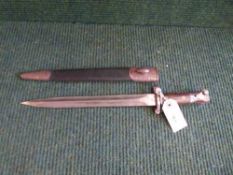 An early 20th century bayonet in leather scabbard