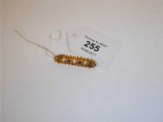 A 9ct gold ruby and seed pearl set bar brooch