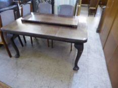 A late Victorian mahogany wind out table with leaf and handle