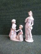 Two Nao figures - two girls with flowers and girl in purple dress
