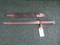 An early 20th century bayonet in leather scabbard