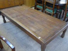 An Oriental hardwood cane topped low table
