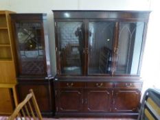 A mahogany triple door glazed bookcase together with matching corner cabinet