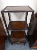 A Chinese hardwood two tier display stand with cupboard below