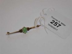 A 9ct gold and jade bar brooch