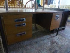 A mid twentieth century teak twin pedestal desk