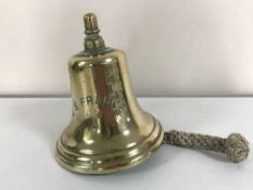 An antique ship's brass bell with inscription 'S.S France'.