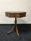 A octagonal yew wood drum table with tooled leather top