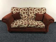 A three piece contemporary lounge suite upholstered in a red floral fabric