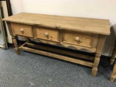 A reclaimed pine hall table fitted with three drawers